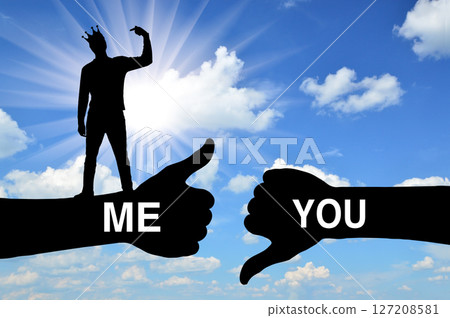 Selfishness. Selfish man with a crown on his head points his finger at himself, considering himself better than others 127208581