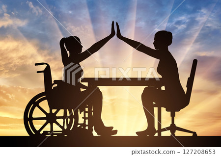Empowering Women in Wheelchairs High Five Teamwork Sunset 127208653