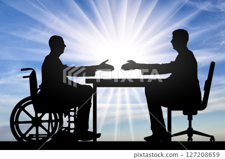 Inclusive Workplace Opportunity: Silhouetted Figures Shake Hands Across a Table, Symbolizing Equality and Accessibility for Disabled Employees Inclusive Workplace Opportunity: Silhouetted Figures Shake Hands Across a Table, Symbolizing Equality and Accessibility for Disabled Employees 127208659