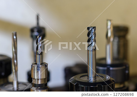 Close-up scene the used flat nose or square solid end mill tools. Close-up scene the used flat nose or square solid end mill tools. 127208698