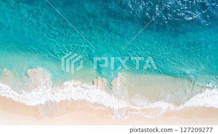 waves on the beach, view of a sandy beach with a gentle ocean wave washing ashore. The soft foam contrasts with the fine sand, peaceful coastal scene, smooth sand in the foreground, gentle ocean wave 127209277