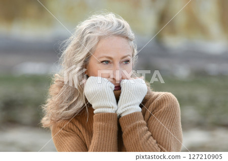 Portrait of a sixty-year-old woman with a gray hair 127210905
