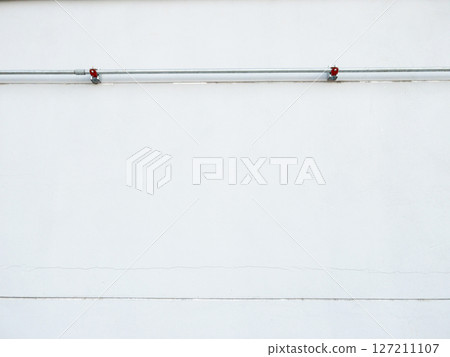 Steel Conduit Pipes on White Factory Wall. 127211107