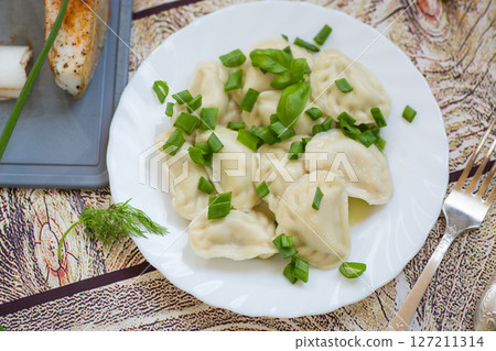 Homemade dumplings with potato filling and fresh herbs Homemade dumplings with potato filling and fresh herbs 127211314