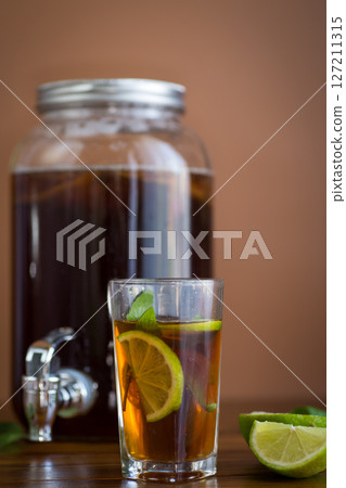 Refreshing kombucha in a glass jar and a glass with lime 127211315