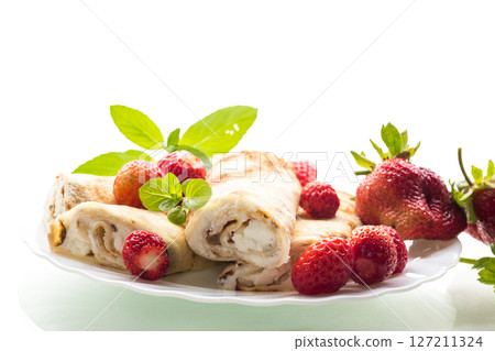 Appetizing pancakes with berries isolated on white Appetizing pancakes with berries isolated on white 127211324