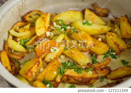 Appetizing baked potatoes with garlic and herbs Appetizing baked potatoes with garlic and herbs 127211349