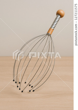 Scalp Massager with Wooden Handle on Neutral Background  Relaxation Tool Concept Scalp Massager with Wooden Handle on Neutral Background  Relaxation Tool Concept 127211575