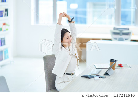 Woman taking a deep breath indoors 127211610