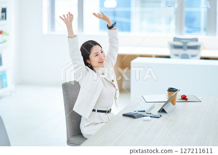 Woman taking a deep breath indoors 127211611