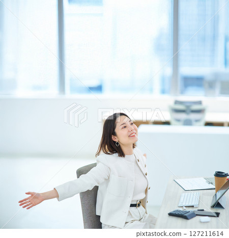 Woman taking a deep breath indoors 127211614