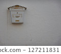 White mailbox hanging on a white wall 127211831