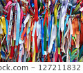 Colorful ribbons adorning a railing on a bridge 127211832