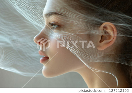 Thin transparent threads of fragrance surround the beautiful face of a young woman. 127212393