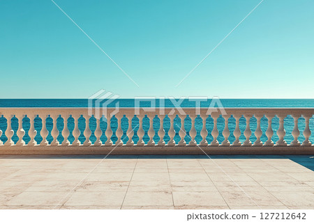 An empty observation deck with a white fence and columns overlooking a calm ocean on a sunny day. An empty observation deck with a white fence and columns overlooking a calm ocean on a sunny day. 127212642
