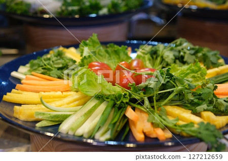 cutting vegetables on a plate different vegetables and greens for spring rolls cutting vegetables on a plate different vegetables and greens for spring rolls 127212659
