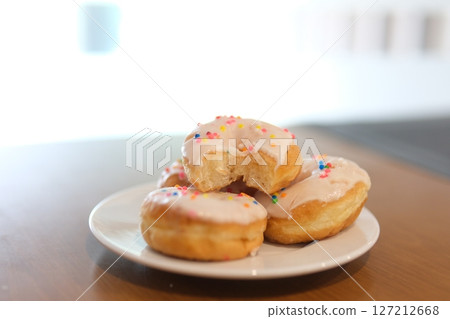 Delicious assorted colorful donuts on the table. 127212668