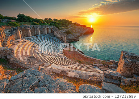 Ancient amphitheater overlooking the sea at sunset 127212689