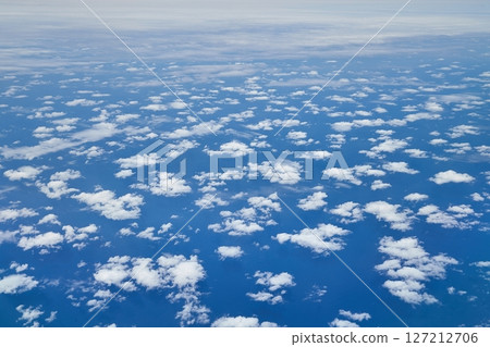 Flying above open ocean and clouds 127212706