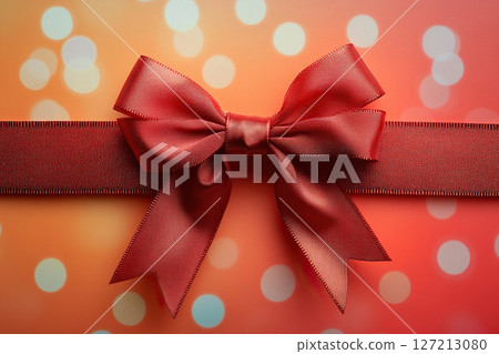 Red satin bow with ribbon on blurred red background with bokeh. Generated by artificial intelligence 127213080