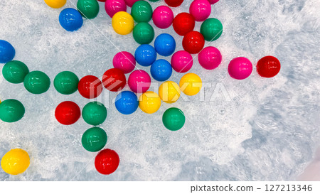 Colorful plastic balls floating on bubbling water surface 127213346