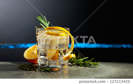 Refreshing gin-tonic cocktail with lemon and rosemary. 127213420
