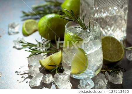 Gin and tonic cocktail made with dry gin, tonic water, lime, and ice. Gin and tonic cocktail made with dry gin, tonic water, lime, and ice. 127213430