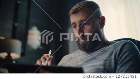 Financial Analyst, Businessman Talking on Phone, Working on Tablet Computer, Monitoring Real-Time Stocks Financial Analyst, Businessman Talking on Phone, Working on Tablet Computer, Monitoring Real-Time Stocks 127213451