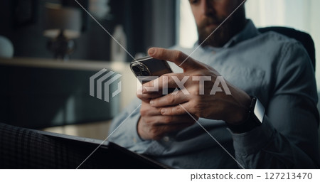 Close Up of Successful Businessman Working on Smartphone, Monitoring Exchange Market Charts 127213470