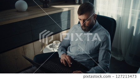 Financial Expert Working on Laptop, Monitoring Exchange Market Charts, Making Investments Financial Expert Working on Laptop, Monitoring Exchange Market Charts, Making Investments 127213473