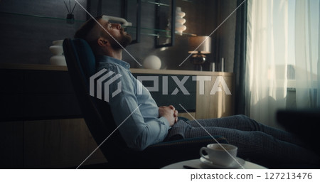 Successful Businessman Sitting in Chair with Closed Eyes, Resting After Work and Hard Trading Day 127213476