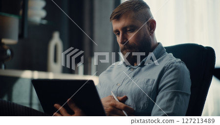 Concentrated Stock Exchange Broker Using Tablet Computer and Digital Pencil, Monitoring Exchange Market Charts 127213489