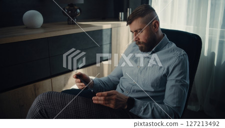Financial Expert Working on Tablet Computer, Monitoring Real-Time Stocks and Exchange Market Charts 127213492