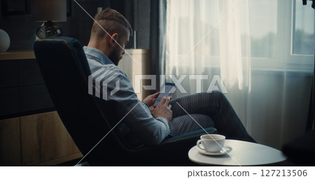 Financial Expert Working on Smartphone, Monitoring Real-Time Stocks in Online Trading App 127213506