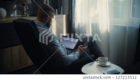 Stock Exchange Trader Using Tablet Computer and Smartphone, Monitoring Real-Time Stocks in Trading App 127213512