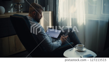 Stock Exchange Trader Using Tablet Computer and Smartphone, Monitoring Real-Time Stocks in Trading App Stock Exchange Trader Using Tablet Computer and Smartphone, Monitoring Real-Time Stocks in Trading App 127213515