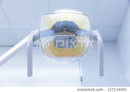 Close-Up View of a Dental Light Fixture in a Modern Clinic: Essential Equipment for Dental Procedures and Patient Comfort During Treatment Sessions 127214041