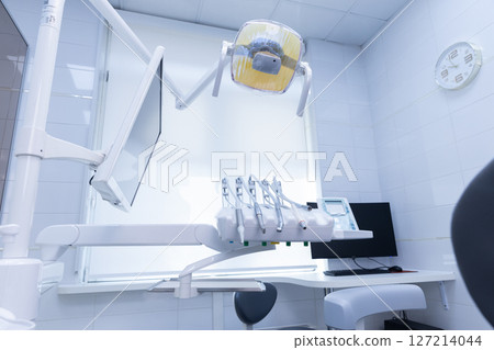 Modern Dental Clinic Interior with Advanced Equipment and Well-Designed Treatment Area for Patient Comfort and Efficient Dental Procedures 127214044