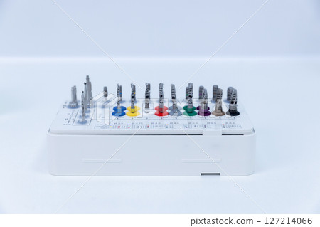 Precision Screwdriver Set with Color-Coded Bits on a White Base for Easy Identification and Organization of Tools in Various Engineering and DIY Tasks 127214066