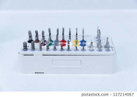 Comprehensive Set of Precision Tools Organized Neatly on a White Tray Showcasing Various Drill Bits and Accessories Ready for Professional Use in Engineering or Craft Applications 127214067