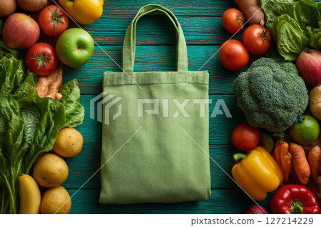 Reusable grocery bag surrounded by fresh fruits and vegetables 127214229