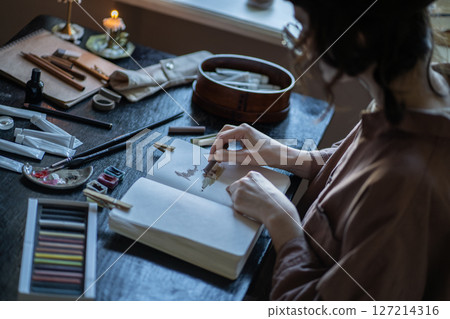 Woman illustrator, cartoon artist, visual designer working in studio. Professional artist work Woman illustrator, cartoon artist, visual designer working in studio. Professional artist work 127214316