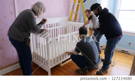 Family gathers to assemble a crib in a cozy nursery during a sunny afternoon at home 127214880
