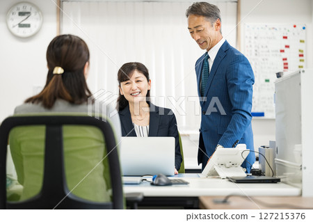 Middle-aged and senior business people working in an office Middle-aged and senior business people working in an office 127215376