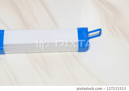 Long Rechargeable LED Flashlight with Blue Handle Isolated on White Background 127215513