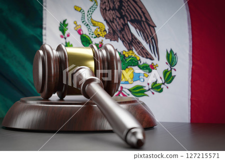 Wooden Gavel Resting on Table In Front of Mexican Flag Wooden Gavel Resting on Table In Front of Mexican Flag 127215571