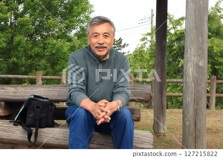 An old man taking a break during a drive 127215822