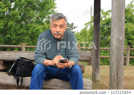 An old man taking a break during a drive An old man taking a break during a drive 127215854