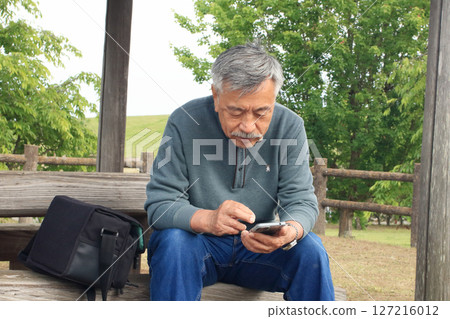 An old man taking a break during a drive 127216012