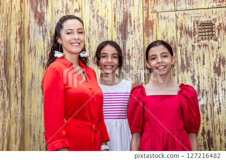 Young mother and her daughters traveling together.  Family love concept. Travel concept. Cartagena de Indias. 127216482